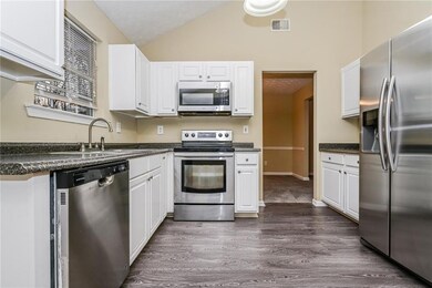 Kitchen featuring white cabinets, stainless steel 