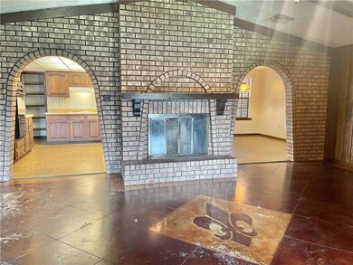 Living into kitchen and dining. Scored concrete fl