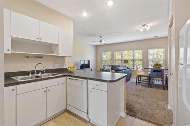 Kitchen with open floor plan, white appliances, a 