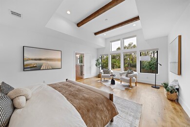 Primary bedroom features hardwood floors, charming