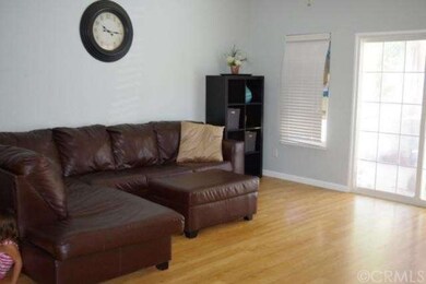Living room with laminate floors, sliding doors on