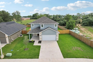 Traditional home with a front lawn, driveway, fen