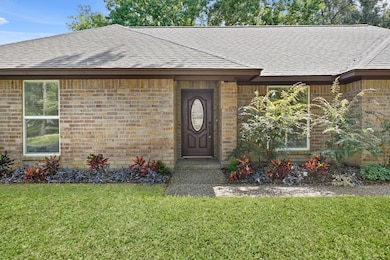 Warm wood door with glass detailing sets the tone for what’s inside.