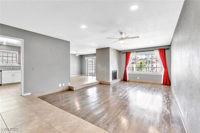 Unfurnished living room featuring a sink, light wo