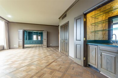 Living room has wet bar that can be closed when no