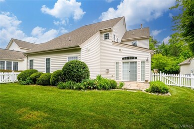 Rear view of house featuring a yard