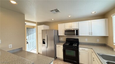 Kitchen with visible vents, a sink, stainless stee