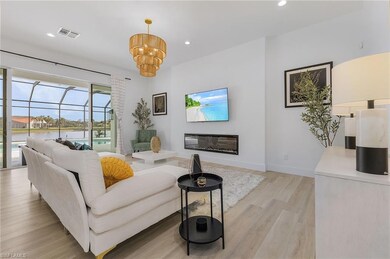 Living room with a chandelier and light hardwood /