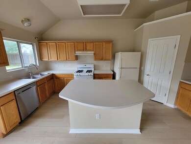 Kitchen featuring lofted ceiling, white appliance