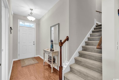 Foyer entrance featuring stairs, baseboards, and w