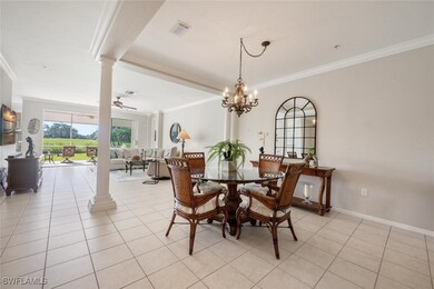 Tiled dining space with ceiling fan with notable c