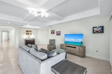Living area with light tile patterned floors, arch