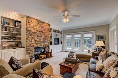 The spacious living room is a wonderful place to relax after a long day or gather for informal occasions. The stacked stone fireplace offers elegant warmth.