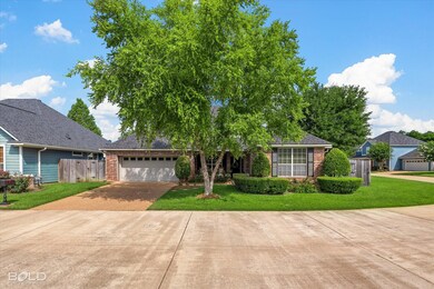 View of front facade with a garage and a front law