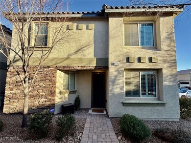 View of front of house featuring a tiled roof and