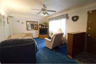 Living Room. Coved ceilings add character to the f
