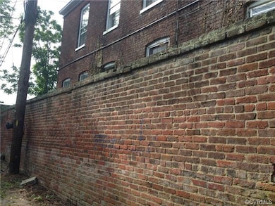 ALLEY SIDE BRICK WALL.