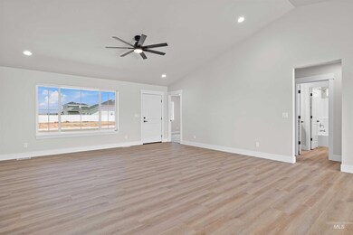 Unfurnished living room featuring vaulted ceiling, a ceiling fan, recessed lighting, and light wood-type flooring