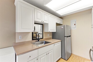 Opposite the stove, the stainless-steel sink and r