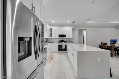 Kitchen with stainless steel appliances, light mar