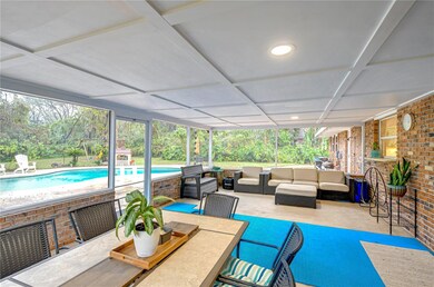 This inviting patio overlooks your private oasis, complete with a sparkling pool and lush greenery