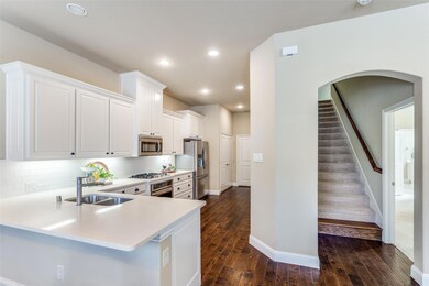Kitchen featuring stainless steel appliances, a si