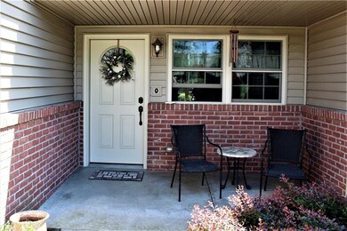 Front.  Mature landscaping invites you on to the c