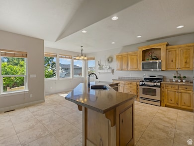 Kitchen with stainless steel appliances, recessed lighting, decorative light fixtures, a chandelier, and open shelves