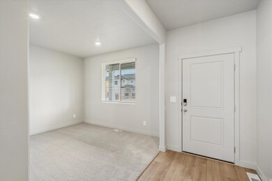 Foyer featuring light wood-style floors and recessed lighting
