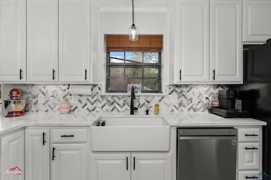 Kitchen with white cabinets and a sink