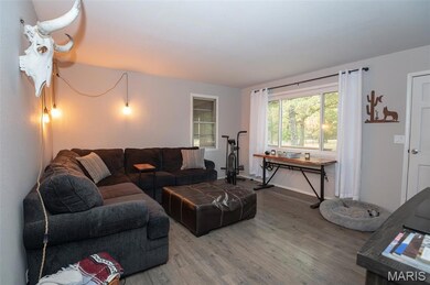 Living room with wood finished floors and baseboards