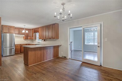 Kitchen/Dining Room with French Doors leading to the Den