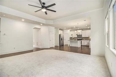 Unfurnished living room featuring crown molding, d