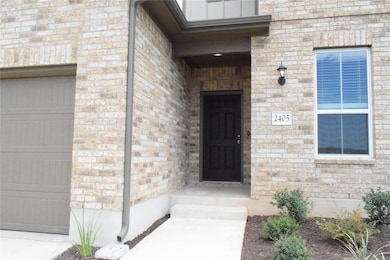 Doorway to property featuring a garage