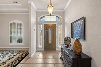 Entryway with plenty of natural light, crown mold
