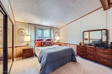 Bedroom with crown molding, a textured ceiling, an