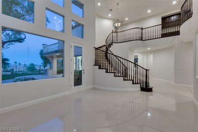 Living room with view windows and sweeping stairca