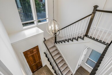 Staircase featuring a chandelier and wood finishe