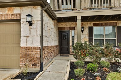 Beautiful stone and brick elevation, pretty landscaping, front porch