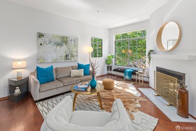 The living room boasts a wood-burning fireplace with modern surround and hearth.