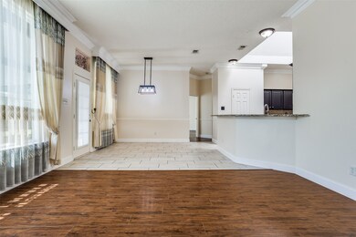 Unfurnished living room with visible vents, light wood-style flooring, baseboards, and crown molding