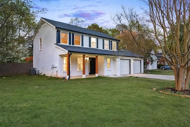 View of front of home with a front yard, concrete 