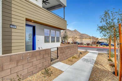 View of side of home with fence and a mountain view