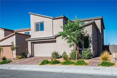 View of front of house with stucco siding, a garag