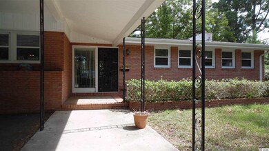To the right of the carport.