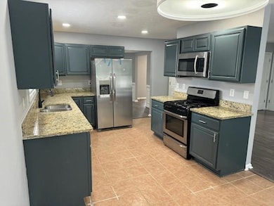 Kitchen with recessed lighting, a sink, appliances