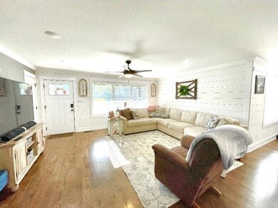 Great Room w/Wood Flooring, Shiplap Wall & Lots of Natural Lighting