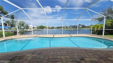 Outdoor pool with glass enclosure, a water view, a