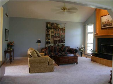 The formal living room includes a cathedral ceilin