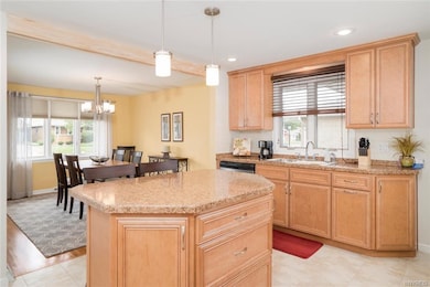 Center island/breakfast bar has cabinets and drawe